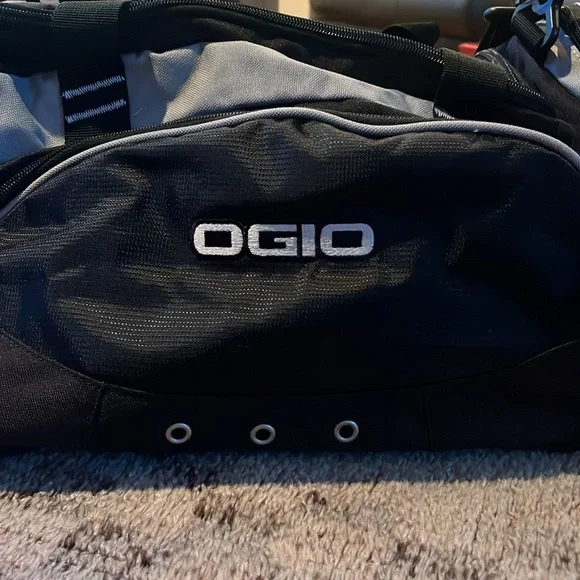 New OGIO sports illustrated black and gray duffle bag with shoulder strap.